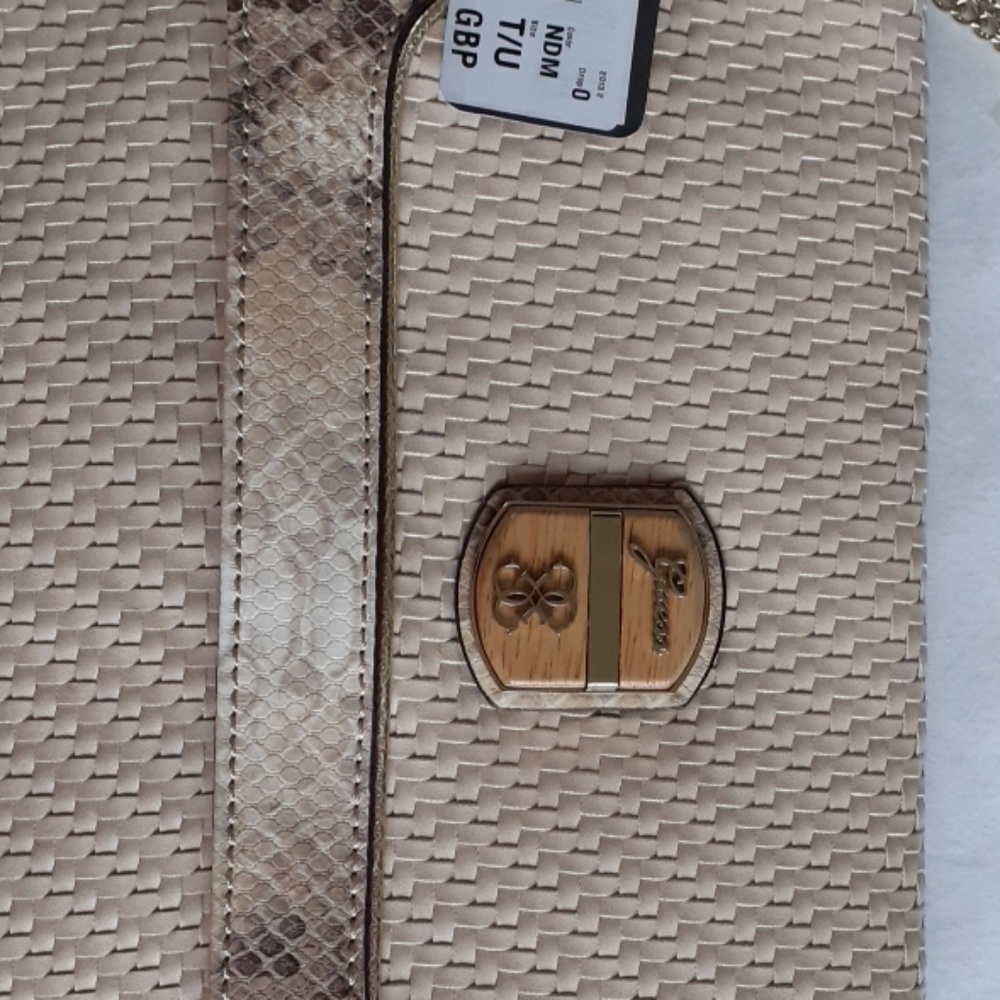 A light brown clutch from guess